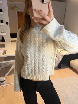 Vit kabelstickad tröja från H&M - Kabelstickad vit tröja från H&M med rund halsringning och långa ärmar. En liten fläck på backsidan, skulle tro att den går bort i tvätten! 😊
