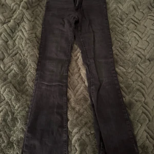 Svarta bootcut jeans från ONLY, M/34 - Snygga svarta jeans från ONLY i bootcut-modell. Jeansen har klassisk femficksdesign, normal passform och är tillverkade i ett stretchigt jeanstyg som sitter skönt. Perfekta för dig som gillar en tidlös look med lite utsvängda ben. Skärp grejen har gått sönder på båda sidorna annars super snygga