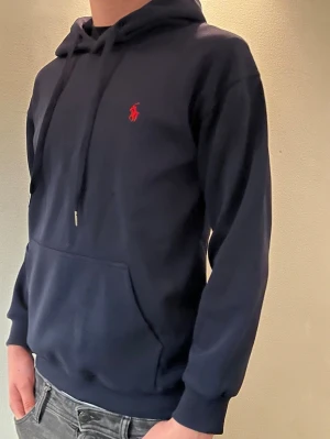 Mörkblå ralph lauren hoodie - Mörkblå ralph lauren hoodie som sitter skönt runt midjan, armar osv. Perfekt för kyligare förhållanden. Modellen är 184 CM lång och väger 71kg‼️