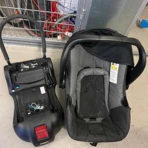 Axkid bilbarnstol med bas - Axkid babyskydd med tillhörande bas.  Perfekt för bilresor med små barn. Behöver en tvätt har varit i källaren.