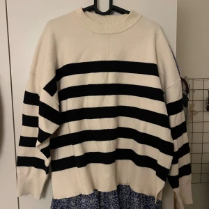 Randig beige och svart stickad tröja - Säljer en oversized stickad tröja från HM. Perfekt till hösten/vintern eller att dra över på sommaren. Stl s/m💌💌 nästan aldrig använd 
