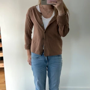 Brun kofta från Rosemunde - Säljer en superfin brun kofta från Rosemunde. Den är gjord av 70% ull och 30% kashmir, vilket gör den både varm och mjuk. Koftan har långa ärmar och knappar framtill. Perfekt för höst och vinter. Kom gärna med prisförslag!🧡