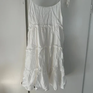 Vit omlottklänning med volanger -  Vit söt kort klänning ifrån SHEIN i storlek XS. Använd bara ett fåtal gånger! 