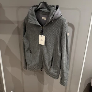 Grå moncler cardigan - Tja! Säljer denna riktigt unika moncler cardiganen i nyskick. Storlek XL men sitter mer som L. Han på bild är 185cm, 74kg. Hör av er vid funderingar!