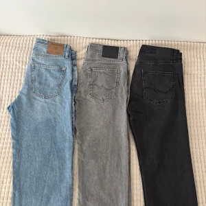 3-pack Jack & Jones jeans i olika färger - Säljer tre par jeans från Jack & Jones i olika färger: svart, grå och blå. Alla i storleken W30/L30. Modell relaxed/chris i grå och svart. Modell loose/eddie i blå. Alla är nytvättade och i mycket bra skick. Går att köpa enskild vid begäran.