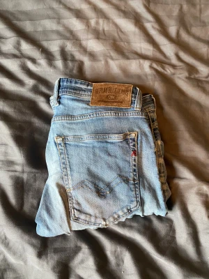 Replay Grover Jeans - Säljer ett par ljusblå Replay Grover jeans i storlek w31 L 32. Jeansen är i rätt bra skick förutom hålen ( se de två sista bilderna). Det kan dock vara snyggt om man gillar att de är lite slitet. Skriv om ni undrar något.