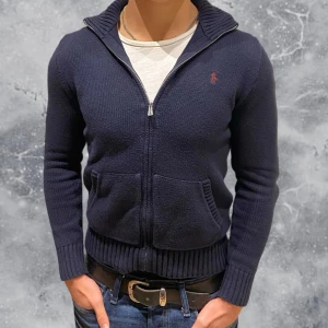 Ralph Lauren Full Zip Tröja  - •Ralph Lauren Full zip tröja navy blue. Skick: 8/10, inga skador! Storlek: 14/16 yrs = XS. Mått: längd: 59 cm, bredd: 41 cm (dvs liten i storlek).  Modell: 173 cm, 63 kg. Authentic: ✅. Hör av dig vid frågor eller funderingar. Kan pruta vid snabb affär