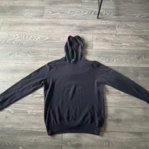 Mörkblå cashmire hoodie  - Mörkblå hoodie från Oscar Jacobson. Jag köpte denna på nk i Göteborg för 1,700 kr den är använd några gånger men it alls mycket och den har inga defekter så den e som ny. Har kvitto och påse för den