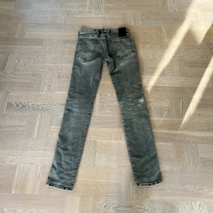 Grå Replay Anbass hyperflex jeans - 29/34. Snygga grå jeans från Replay med slitna detaljer och klassisk femficksdesign. Använda ett fåtal gånger.😝