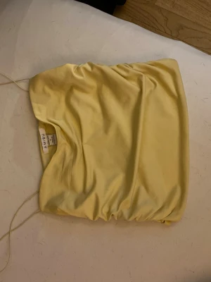Gul croppad topp från Amisu - Snygg gul croppad topp från Amisu med tunna axelband och enkel design. Perfekt för dig som gillar en stilren look med en poppig färg. Materialet känns mjukt och lätt, vilket gör toppen skön att bära under varma dagar.