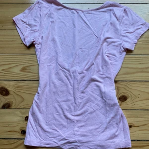 Rosa t shirt från lager 157 -  Säljer en rosa t-shirt från lager 157 med öppen rygg. Det ser lite konstigt ut på bilderna men ser mycket bättre ut på det finns ingen lapp där det står vilken storlek det är då jag är väldigt känslig mot saker som kliar men tröjan sitter som en XS❣️