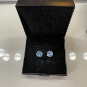 Set med silvriga örhängen med blå stenar - Säljer ett set med tre par silvriga örhängen med runda, gnistrande blå stenar i olika storlekar. Perfekta för att mixa och matcha💖