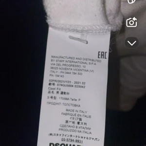 DSQUARED2 sweatshirt vit  - Vit sweatshirt från DSQUARED2 med stor svart 'ICON'-print på bröstet och logga ovanför. Tröjan har rund hals, långa ärmar och ribbade muddar. Tillverkad i Italien i mjuk bomull, perfekt för dig som gillar clean och stilren streetwear.ÄKTA disquared2 sweatshirt bra skick. Skriv gärna frågor 🤍.storlek S