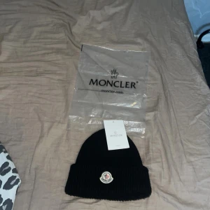 Moncler mössa  - Hej jag säljer denna moncler mössa i gott skick  Om du vill ha med frågor kontakta mig! Priset kan diskuteras utan påse å tag