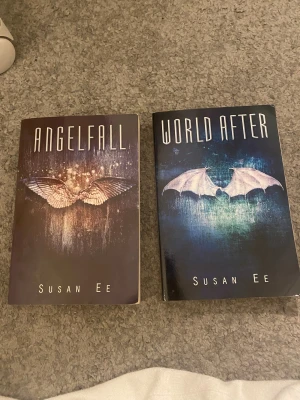 Angelfall & World After - Två böcker av Susan Ee med snygga omslag som visar vingar och en mystisk, mörk stämning. Perfekt för dig som gillar spännande och övernaturliga berättelser med fantasykänsla. Passar unga vuxna som vill ha något fängslande att läsa! HELT NYA!!