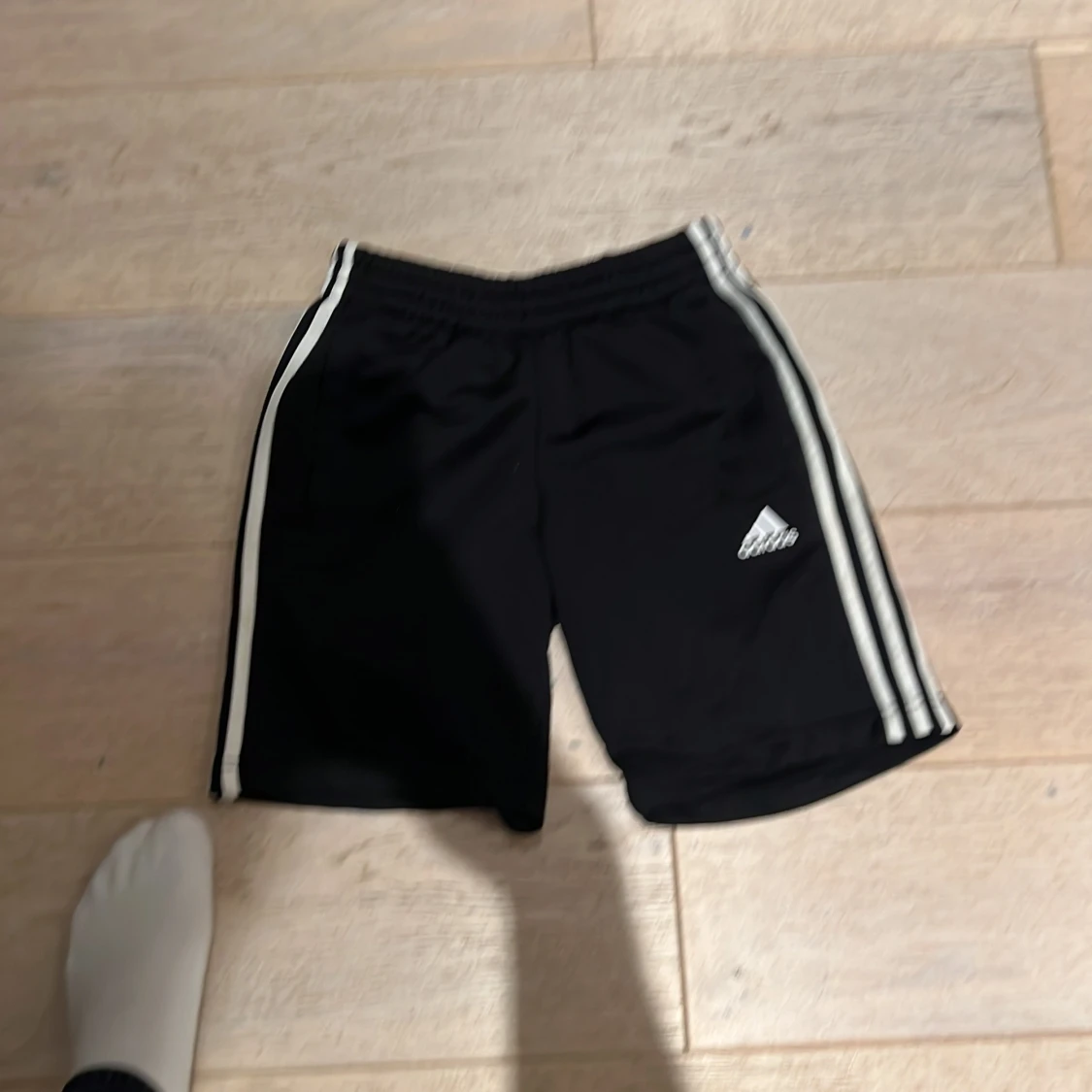 Svarta Adidas shorts med vita ränder