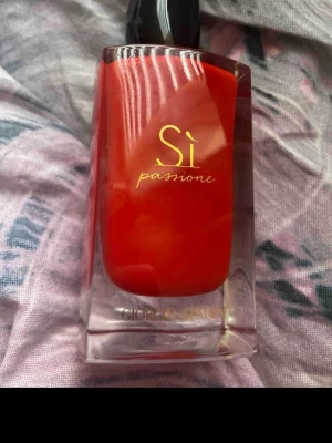 Sì Passione Eau de Parfum 100ml - Sì Passione från Giorgio Armani är en eau de parfum i en snygg röd flaska. Volymen är 100 ml, perfekt för dig som vill ha en ikonisk doft på hyllan. En klassiker som sticker ut och ger en lyxig känsla i vardagen.