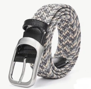 Grått flätat bälte med silverfärgat spänne - Snyggt flätat bälte i olika nyanser av grått och beige med ett stilrent silverfärgat metallspänne. Bältet har svarta skinn-detaljer vid spännet och är perfekt för att ge outfiten en cool touch. Passar till jeans eller chinos för en avslappnad men trendig look.