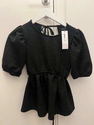 Helt ny svart topp från Gina Tricot  - Säljer denna helt nya svarta toppen från Gina tricot som man knyter i ryggen med 2 snören ❣️ skriv priv för bild på 