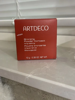 ARTDECO Bronzing Powder Compact - Snygg bronzer från ARTDECO i en rund, brun kompakt dosa med spegel. Pudret är långvarigt och ger en naturligt solkysst look. Förpackningen är påfyllningsbar och innehåller 10 g bronzingpuder. Säljes för att jag råkade köpa i fel färg❤️