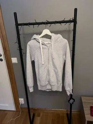 Russemerch hoodzip i grå - En grå hoodie med zip från märket Russemerch. Skicka vid några funderingar!