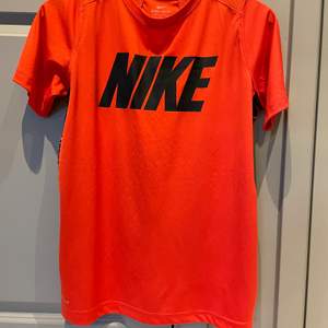Röd träningst-shirt från Nike ❤️ strl XL barn, passar S-M i dam 