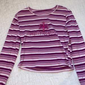 Long-sleeved, striped, purple and pink top with cute lettering and flower patchwork // Good condition // Buyer pays for shipping (even though it says frees shipping in the post) 
