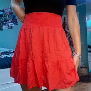 Orange kjol - Supergullig orange (lite åt det röda hållet) kjol 🧡 Lite ribbad upp till magen och lite volangig ner mot benen. Knappt använd och i superfint skick ✨ Storleken är XS men jag skulle säga att den likaväl passar en S