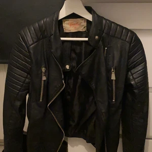 Skinnjacka - Säljer min skinnjacka ifrån chiquelle (moto jacket black)                i Läderimitation. Vänsta fickan är doc trasig (Se bild 3) men de går och stoppa in så de inte syns.                                                    Köparen står för frakt. 