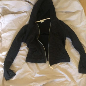 Tröja med luva  - Mörkgrå/svart tröja med luva och dragkedja. Storlek 146/152 men är kroppad så passar en mindre också. Köparen står för frakten 
