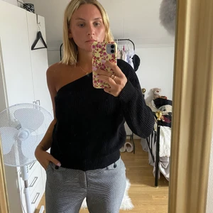 Stickad tröja  - Säljer denna svarta stickade tröja som är one shoulder. Köpt på NA-KD för några år sedan och sparsamt använd. Väldigt skön och snygg passform. Den är i storlek S 🌸