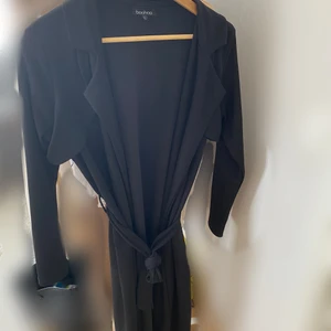 Svart trenchcoat  - Svart trenchcoat, storlek L men passar M också. 