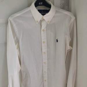 En oanvända Ralph Lauren skjorta i färgen vit med blått märke. Storlek S. Ny pris: 1200kr