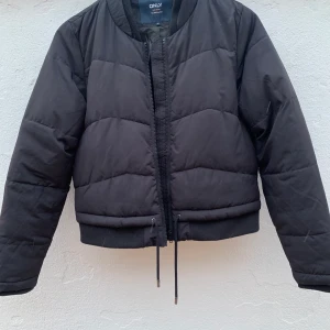 Only täckjacka Strl S - En felfri täckjacka från Only i Strl S. Hel dragkedja fram, sidfickor, muddar i ärmslut. Svart. 