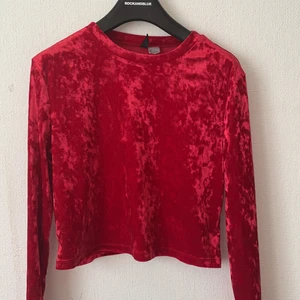 Röd sammet tröja H&M  - En kort topp i röd sammet. Toppen är rundringad och har lång ärm. Använt den några gånger men den är fortfarande fläckfri. 