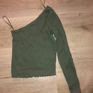 Grön tröja - Dehär är en jättefin grön en arms tröja! Aldrig använd, bara provats. Passar inte i färgen, därför säljer jag den. Skriv för intresse.