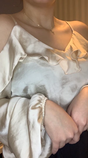 Silkes topp från Gina Tricot i storlek 34 🌸 - Säljer denna fina toppen som endast är använd en gång, ljus beige färg i silkes material med volanger och resår vid händerna. 🌸