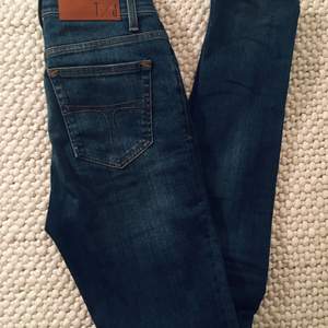Superfina blå jeans från Tiger, modell ”Kelly”. Använda bara ca en gång. Smal passform med hög midja, storlek 28x32 (normal i storleken). Älskar dem men växte ur dem... Köparen står för ev frakt. 