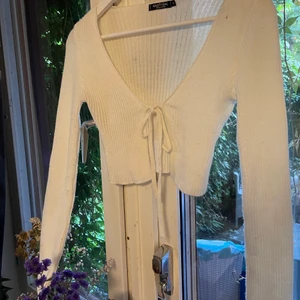 Vit knyt-kofta - Vit stickad kofta som knyts fram. Storlek S.