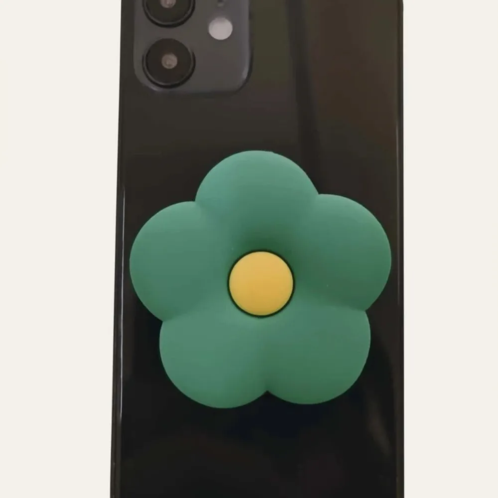 Säljer en ny fin blomma-popsocket. Den är oanvänd och ligger kvar i förpackning.. Accessoarer.