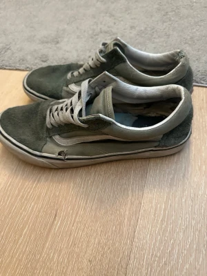 Gröna Vans Old Skool sneakers - (Väl använda som ni ser på bilder, byt sula och snören så har ni ett par vans som ser ok ut)                        Klassiska Vans Old Skool sneakers i grönt mocka och canvas med vit sula och vit sidostripes. Låga med snörning och ikonisk retrostil. Perfekta för dig som gillar streetwear och skatekänsla.