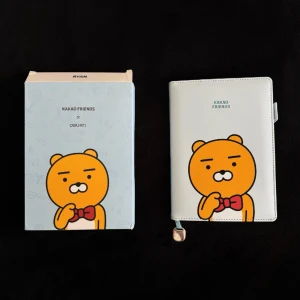 Kakao Friends Notebook  - Probably the most adorable Kakao Friends (Ryan) notebook you’ll ever come across 🩵🧸Made from soft PU leather and has inner compartments for cards, notes etc. Consists of 112 lined pages (180mmx130mm) and the notebook can be removed from its casing. Brand new in box (the original pen is not included with purchase) 🫶🏻