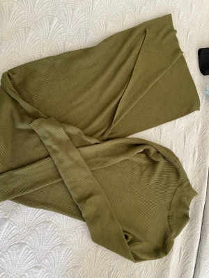 Olivgrön ribbad långklänning  - Otroligt fin ribbad långklänning från Amisu (new Yorker). Lång och har en slits på ungefär 30-40 cm lång. Storlek 34 och använd 1-2 gånger❤️