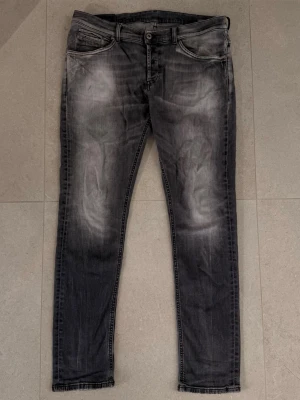 Dondup Jeans - Dondup jeans som passar tydligt in i grischkulturen.     Populär mörkgrå tvätt, tydligen tecken på användning men på har andväts i detta skick och hål finns och sitter på tacksamma ställen.