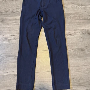 Mörkblå byxor från Jack & Jones - Snygga mörkblå byxor från Jack & Jones med en stilren design. Perfekta för en avslappnad men ändå uppklädd look. Byxorna har en normal passform och är tillverkade i ett bekvämt material.