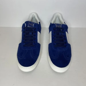 Valentino flycrew | feta | byte gucci keps - Snygga sneakers från Valentino i blå mocka med vita detaljer och platt sula. Skorna har snörning, rund tå och coola nitar baktill. Bytes mot gucci keps eller andra skor