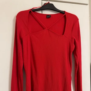 Röd ribbad långärmad topp Gina Tricot - Snygg röd långärmad topp från Gina Tricot med fyrkantig urringning och band över bröstet. Modellen är figurnära och passar till många olika stilar. Jag är storlek M men speciellt denna tröjan (storlek XL) passade mig. Så den passar storlek M och uppåt 