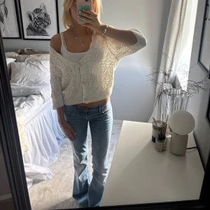 Vit stickad kofta med mönster - Superfin vit stickad kofta med snyggt hålmönster och knappar framtill. 