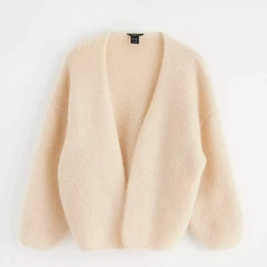 Beige fluffig kofta från & Other Stories - Supermjuk och oversized beige kofta från & Other Stories. Den har en öppen front utan knappar, lång ärm och är stickad i ett fluffigt material som känns lyxigt och mysigt. Perfekt att slänga på sig när det är kyligt ute. PRISET KAN DISKUTERAS 