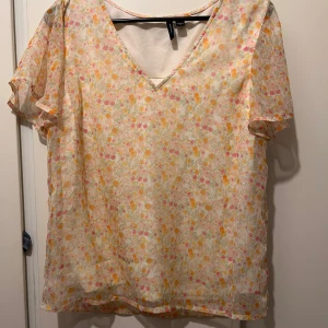 Blommig blus strl XS - Blommig topp i strl XS från Vero Moda. Nyskick, aldrig använd, endast provad. Material: 100% polyester 